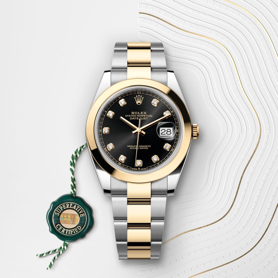 A two-tone Rolex watch with a black dial, diamond hour markers, and a Superlative Certified green tag.