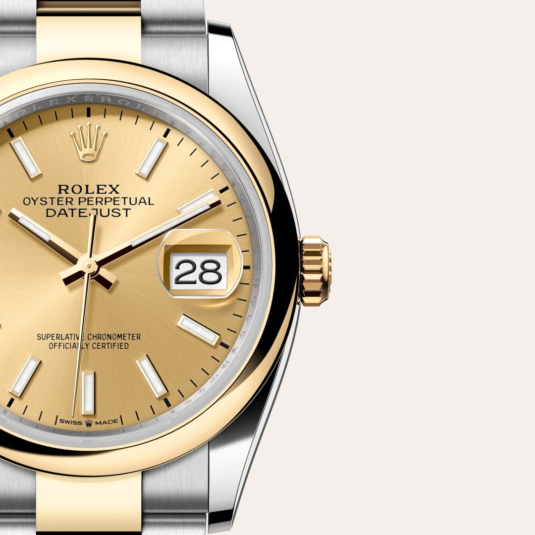 Close-up of a Rolex Datejust watch with a gold dial, date display, and two-tone gold and silver case.