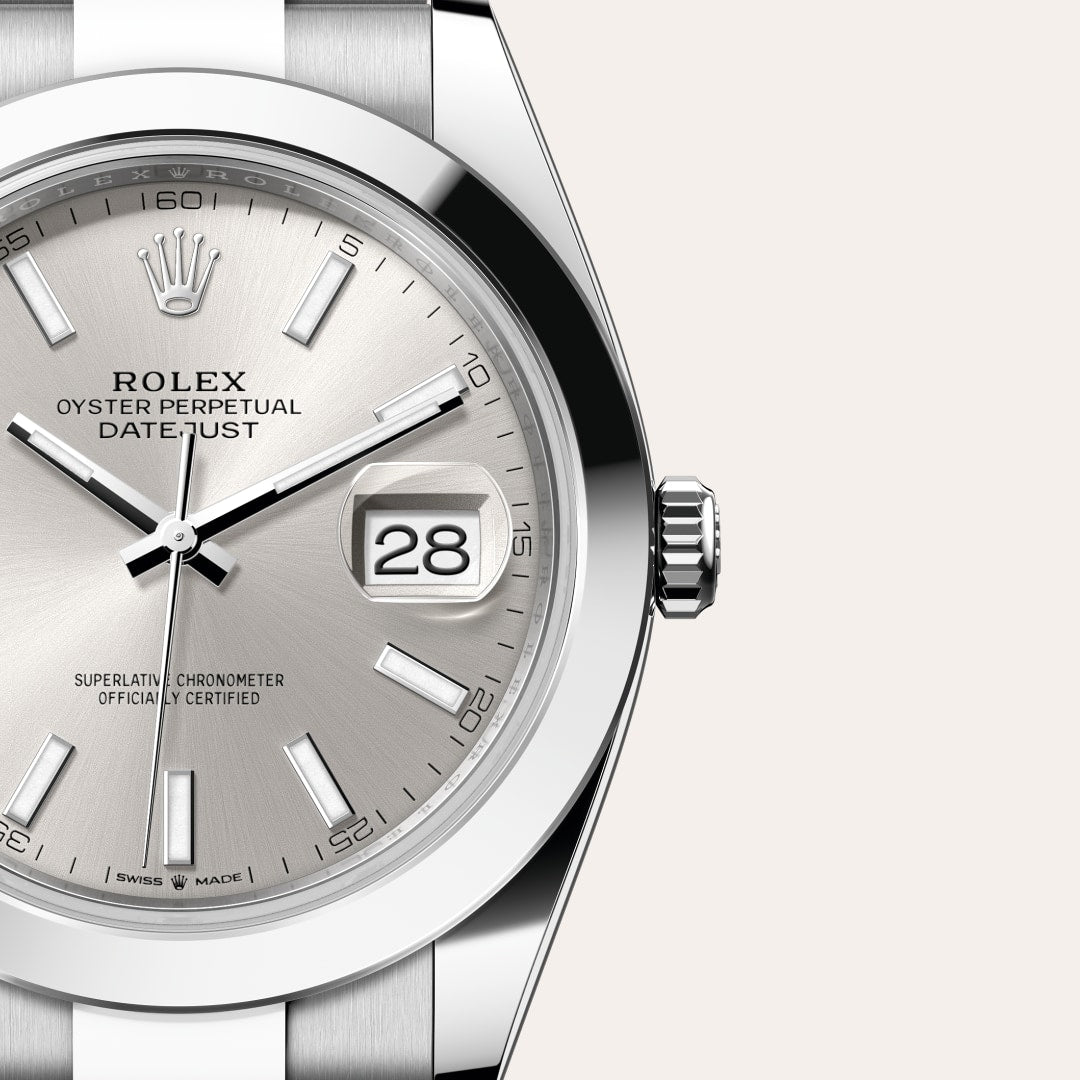 Close-up of a silver Rolex Datejust watch face showing the date as 28, with a stainless steel bezel.