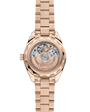 A back view of an Omega Seamaster watch showing the rose gold strap and case with a view of the mechanism inside the watch