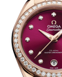 Close up view of the dial of an Omega Seamaster watch with a burgundy dial and diamonds at the hour marks with a rose-gold bracelet