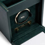 Green leather watch winder with gold-tone mechanism and storage drawer, branded Wolf.