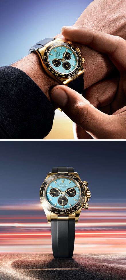 A gold and black wristwatch with a turquoise face, shown on a wrist and set against a blurred background.