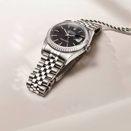 Rolex Datejust watch on a beige background
