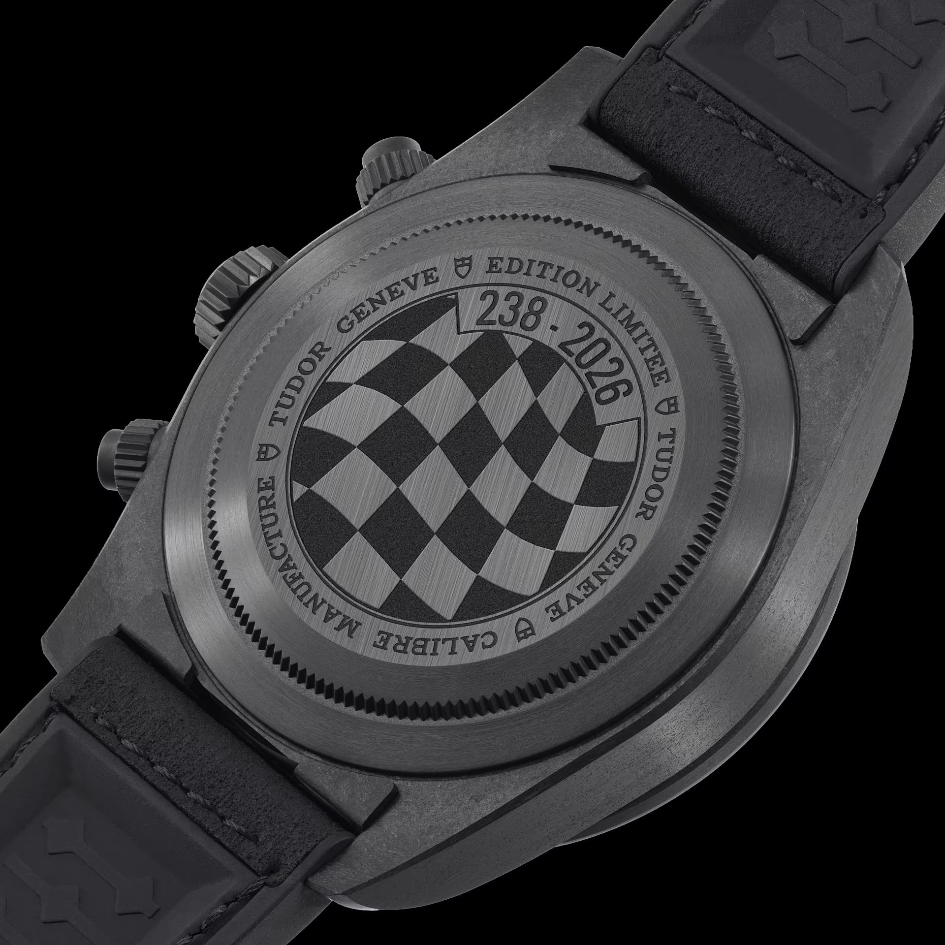 Black Bay Chrono Carbon watch with checkered dial, chronograph pushers, and black rubber strap shown from caseback view.
