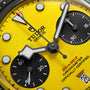 Mens watch with bright yellow dial, black chronograph subdials, white hour markers, and black hands with TUDOR text.